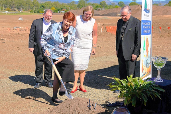 Pam Betts, Executive Director Brisbane Catholic Education turns the sod of the new McAuley College Beaudesert, watched on by Mrs Deidre Young, Foundation Principal, Archbishop Coleridge and Fr Michael McKeaton Pam Betts, Executive Director Brisbane Catholic Education turns the sod of the n